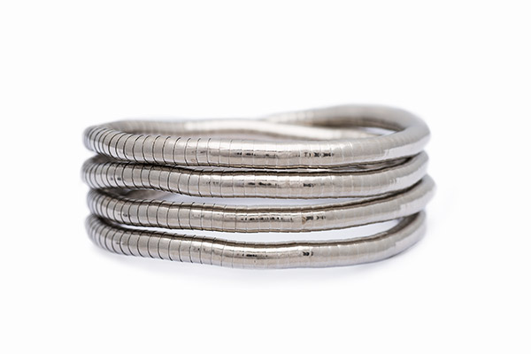 A Silvered Metal Coiled Four Row Flexible Striped Band Bangle