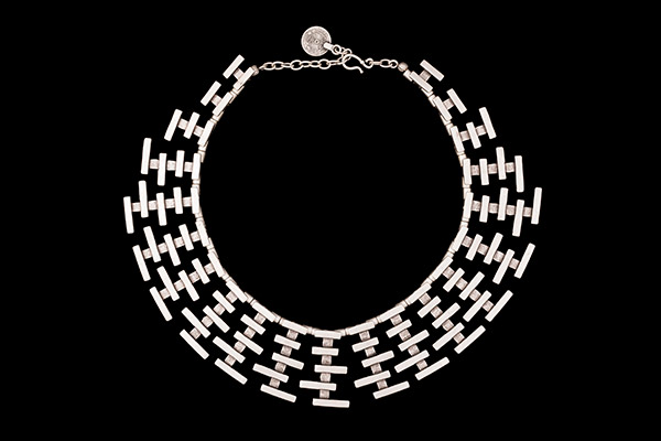 A Silvered Metal Necklace With Twenty-One Graduated Pendants Of Horizontal Silvered Metal Rectangles