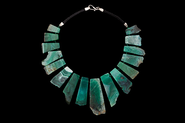 A Knotted Necklace Of Sixteen Green Fluorite Graduated Drops On Two Black Leather Braided Bands