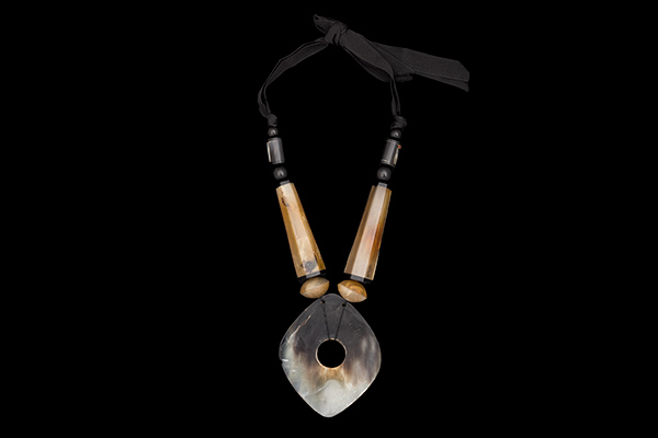 A Long Necklace Of Buffalo Horn Mixed Shaped And Sized Beads With A Large Oval Pendant