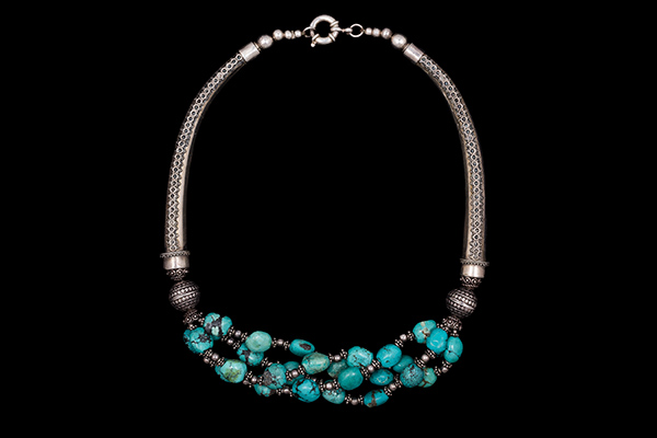A Nepalese Silver Curved Patterned Bars Necklace  With Four Bands Of Turquoise And Silver Beads