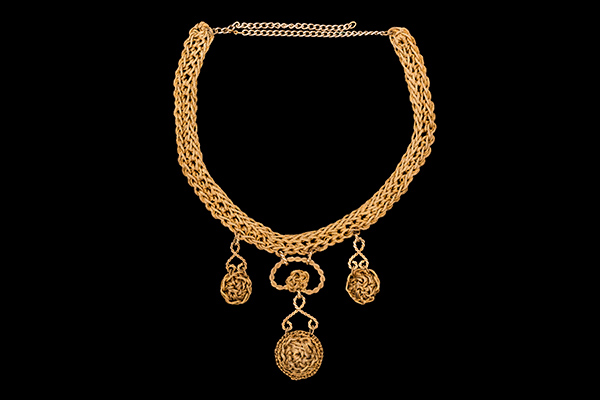 A Golden Metal Braided Band Wire Necklace With Three Circular Pendants Of Golden Metal Braided Wires