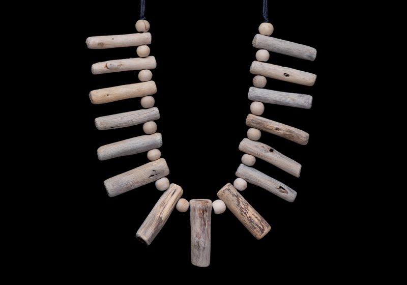 A Balinese Necklace Of Fifteen Bleached Driftwood Tubular Drops With Round Bleached Wood Spacers