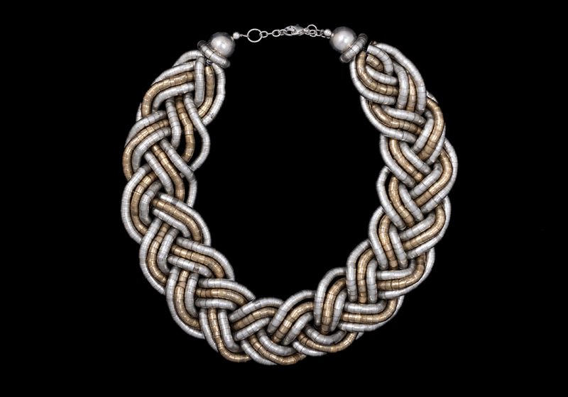 A Wide Braided Necklace Of Six Silvered Metal And Three Golden Metal Flexible Bands