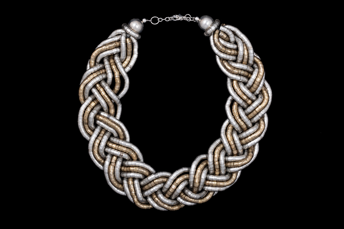 A Wide Braided Necklace Of Six Silvered Metal And Three Golden Metal Flexible Bands