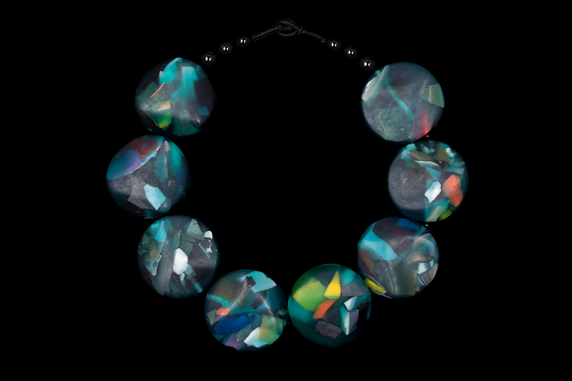 A Necklace Of Javanese Dark Green Resin Smooth Facetted Discs Inlaid With Multicoloured Resin Flakes