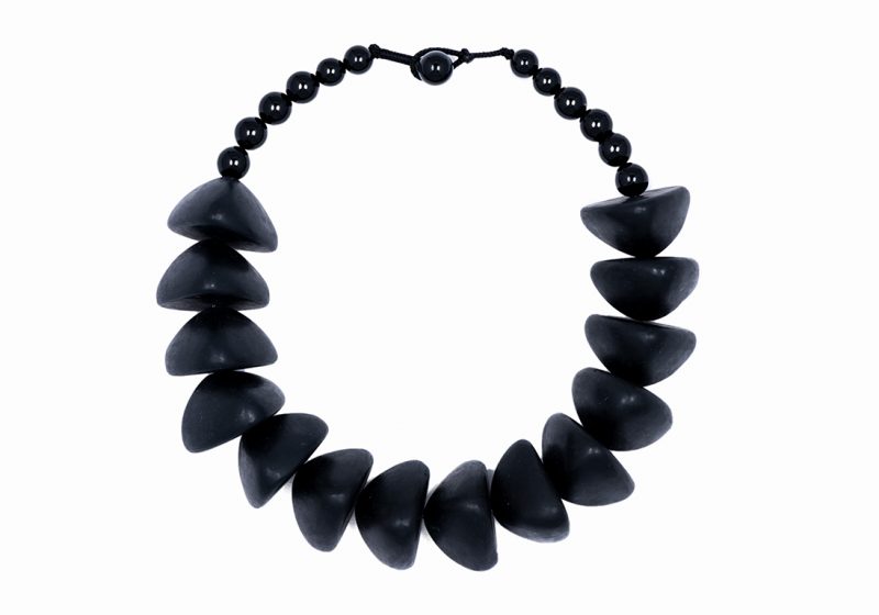 A Necklace Of Fourteen Javanese Black Resin Domed Triangular Large Beads With Black Onyx Beads