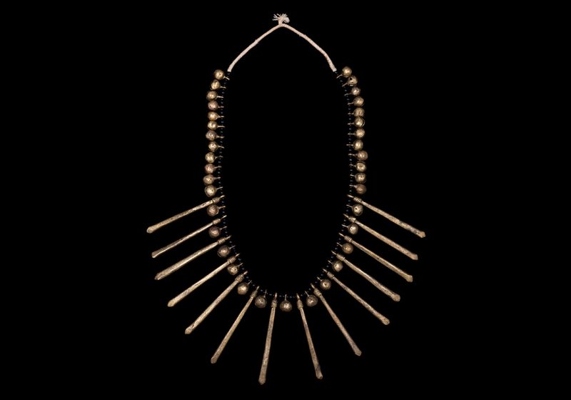 A Baule Necklace Of Small Brass Bells, Long Brass Drops, And Black Onyx Round Beads