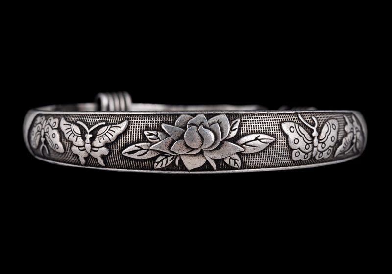 A Miao Vintage Silvered Metal Narrow Bangle Engraved With A Flower And Four Butterflies. China