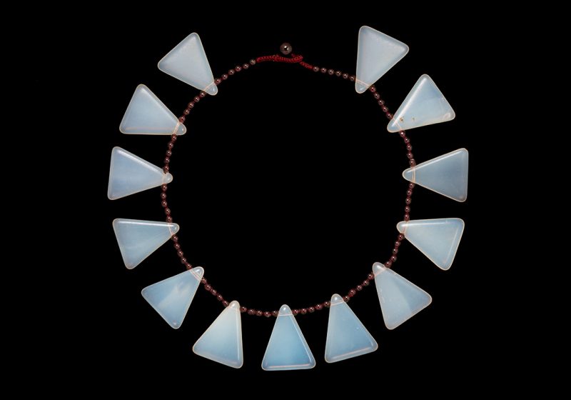 A Necklace Of Thirteen Bohemian Opalescent Glass Triangular Drops With Garnet Round Beads