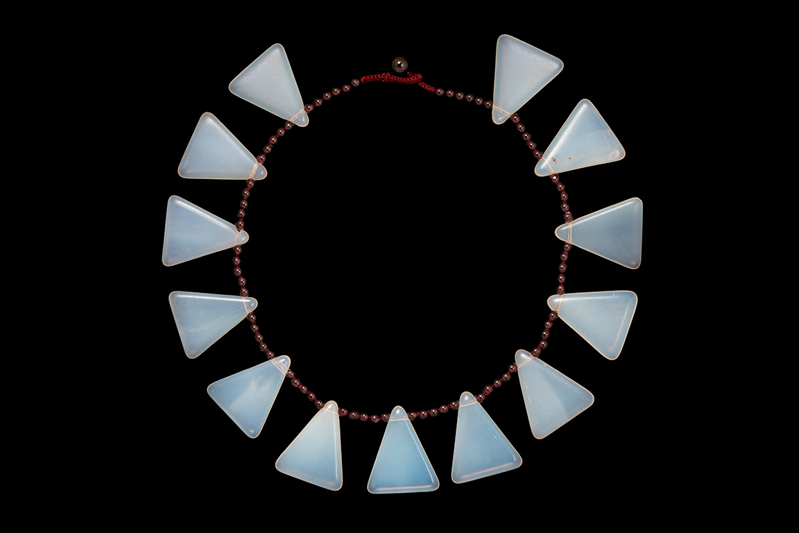 A Necklace Of Thirteen Bohemian Opalescent Glass Triangular Drops With Garnet Round Beads