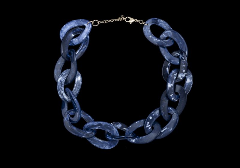 A Necklace Of Fifteen Dark Blue And White Patterned Resin Large, Interlocking, Curved And Oval Loops