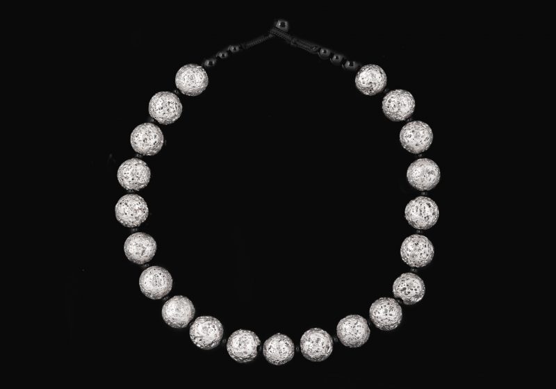 A Necklace Of Twenty-One Silver Electroplated Lava Round Pitted 'Moon' Beads With Black Onyx Beads