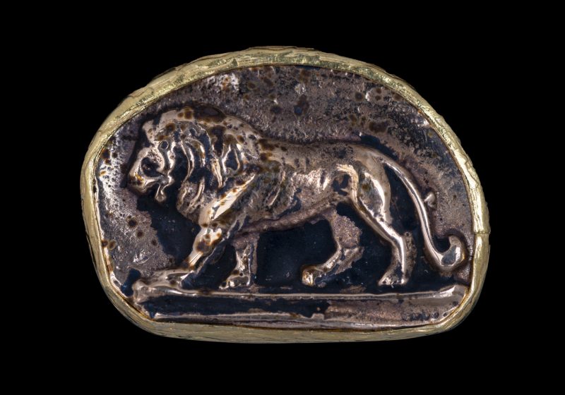 A Gold Plated Adjustable Double Band Ring With A Curved Bezel Patterned With A Lion