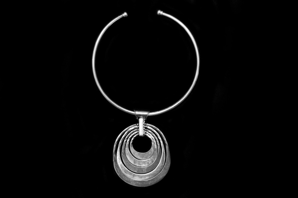 Silvered Metal Five Curved Graduated Bands Pendant On A Silvered Metal Torque Necklace