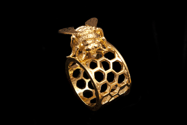 Golden Metal Bee Standing On A Honeycomb Ring