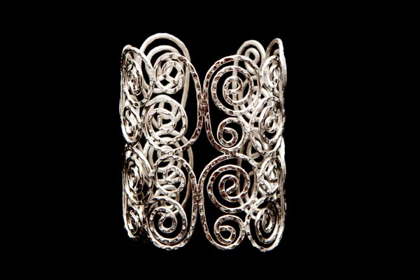 Silvered Metal Hammered Surface Bands Forming A PatternOf Concentric Circles On An Open Cuff