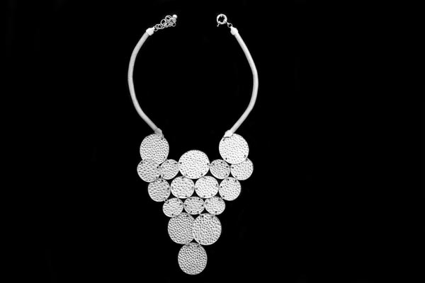 Seventeen Silvered Metal Pitted Surface Linked Circular Discs Forming A Triangular Pendant Necklace