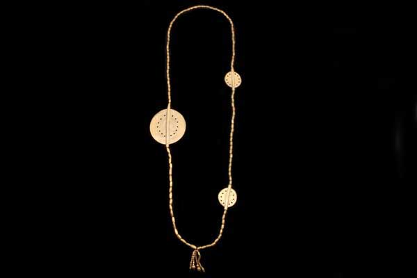 A Baule Brass Tubular Beads Long Necklace With Three Brass Circular Discs