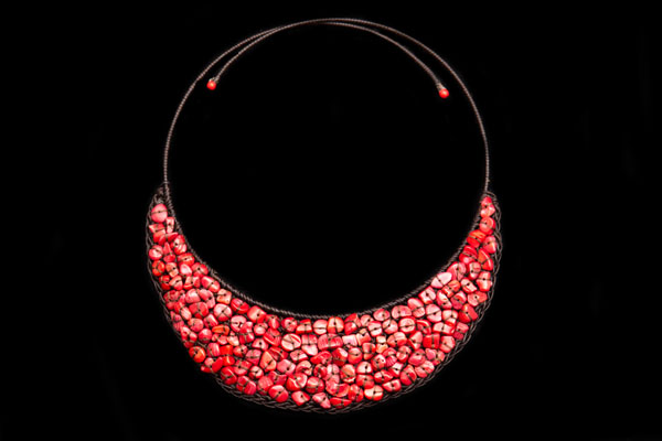 Red Dyed Sea Bamboo Coral Nuggets Attached To A Brown Braided Cord Curved Band Torque Necklace