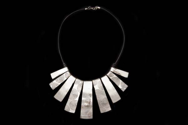 Silvered Metal Nine Graduated Thin Rectangular Pendants Suspended From A Leather Thong Necklace