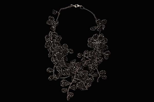 A Floral Patterned Necklace Of Black Facetted Glass Beads Attached To Black Thread Bound 'Branches'