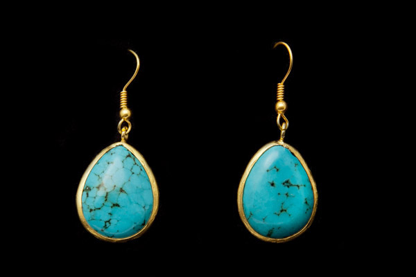A Pair Of Turquoise Domed Teardrop Earrings With Gold Plated Curved Rims And Wire Hooks