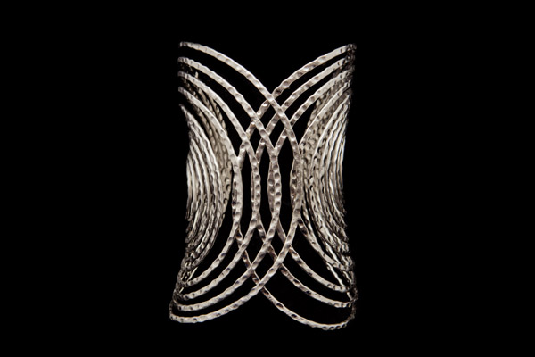 A Silvered Metal Long Open Cuff Of Two Ten Banded Interlocking Ovals