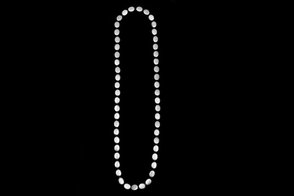 Fifty-One Silvered Metal Flat Oval Beads On A Long Black Cotton Knotted Necklace