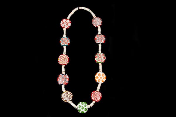 A Long Necklace Of Javanese Large Multicoloured Circular Glass Beads And White Glass Tubular Beads