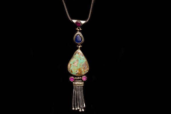 One Silver And Brass Teardrop Pendant Necklace Inlaid With Turquoise, And Pink And Dark Blue Facetted Glass Cabochons