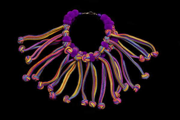 A Purple Wool Pompoms Two Strand Necklace With Long Pendants Of Multicoloured Silk Knotted Strands