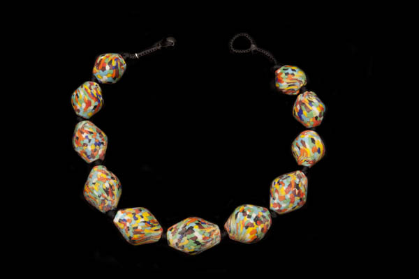 A Knotted Necklace Of Javanese Large Ridged Oval Beads With Multicoloured Glass Inlays