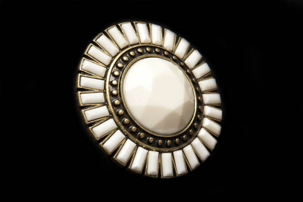 A Large Circular Stylised Flower Ring With A Cream Resin Facetted Centre And Rectangular 'Petals'