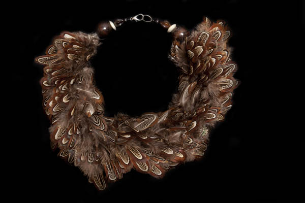 A Necklace Of Small Bunched Pheasant Feathers  And Mixed Shaped Wood, Bone, And Resin Beads