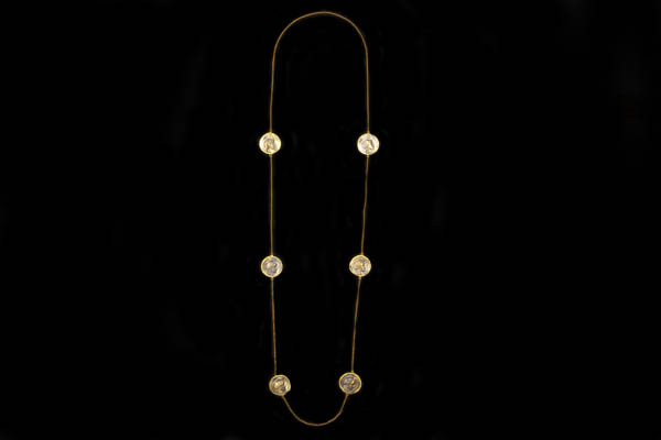A Gold Plated Long Chain Necklace Decorated With Six Bronzed Copies Of Ancient Greek Circular Coins