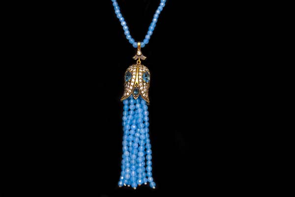 A Long Necklace Of Chalcedony Blue Glass Facetted Beads With A Silvered Metal Fringed Pendant