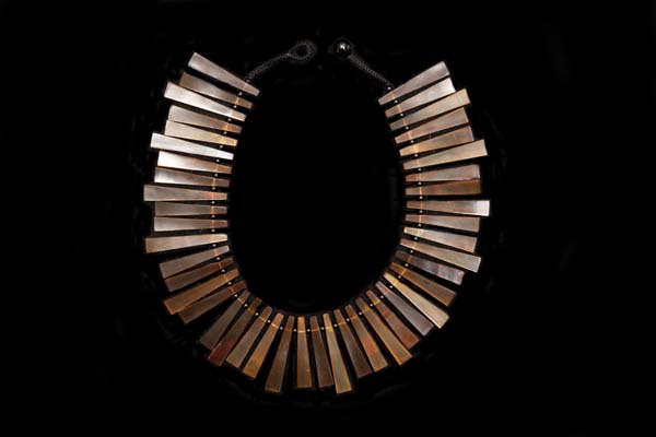 A Necklace Of Brown Buffalo Horn Narrow Triangular Graduated Drops, With Black Agate Small Round Spacers