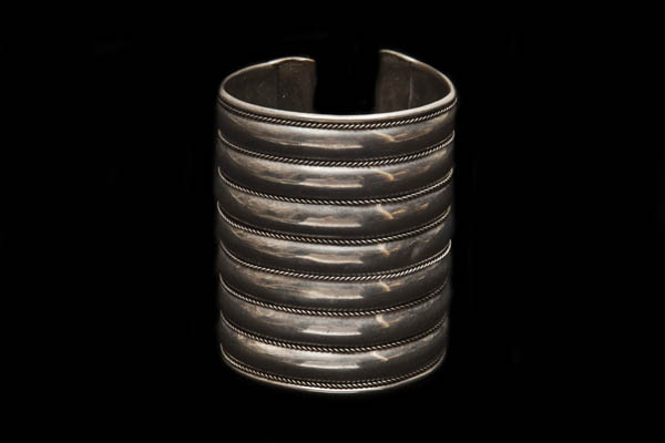 A Silvered Metal Open Cuff Of Seven Curved Top Bands Separated By Eight Twisted Wire Bands