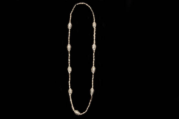 An Indonesian Silvered Metal Beads Long Necklace, Decorated With Nine Silvered Metal Buddha Heads