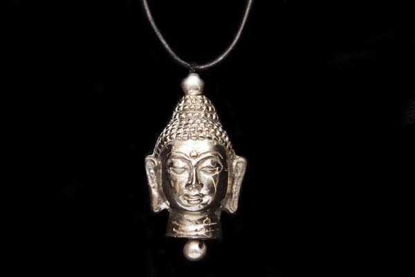 A Javanese Silvered Metal Buddha Head Pendant On A Silver Snake Links Chain Necklace