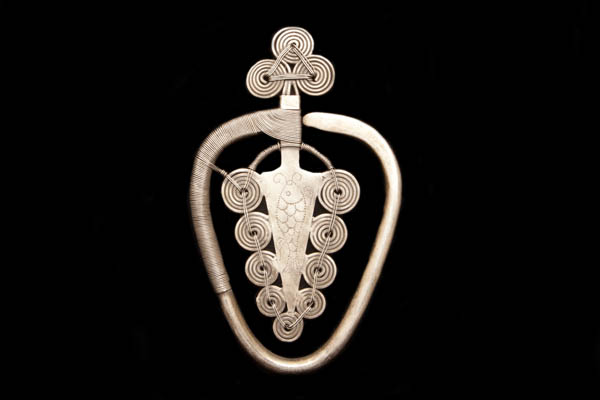 A Miao Silvered Metal Large Triangular Pendant Decorated With Concentric Circular Banded Discs