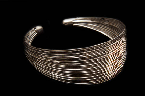 A Tapered Open Cuff Of Thirty Silvered Metal Curved Bands