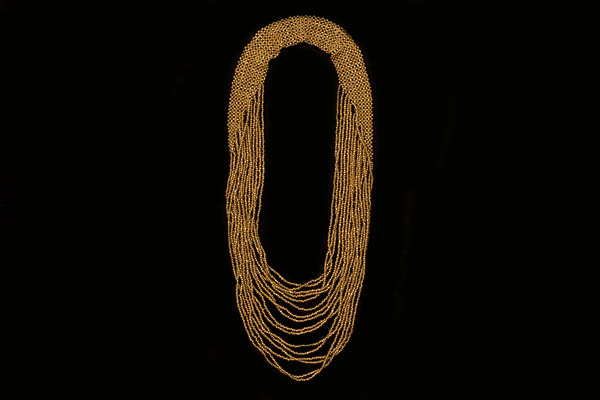 A Long Graduated Sixteen Strands Necklace Of Small Gold Resin Beads With A Crochet Bead Band At The Top