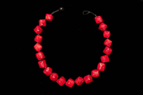 A Knotted Necklace Of Twenty-One Red Dyed Sea Bamboo Coral Smooth Facetted Cube Beads