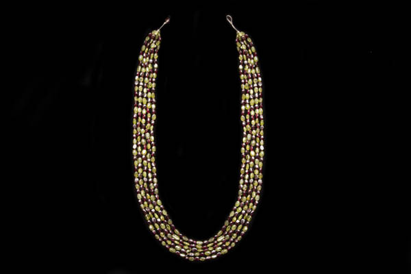 A Long Five Strand Necklace Of Peridot And Garnet Small Oval Beads