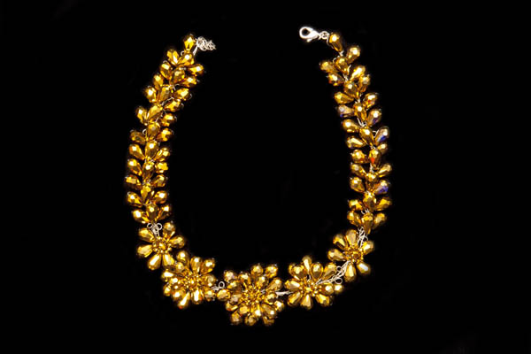 A Floral Patterned Necklace Of Golden Glass Facetted Teardrops On Wire Depicting Flowers And Leaves