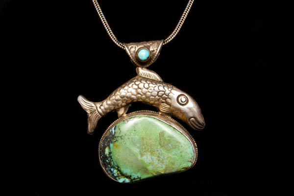 A Tibetan Antique Silver Pendant With A Fish At The Top And Inlaid With A Turquoise Oval Cabochon