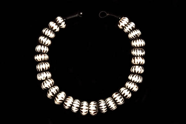 A Necklace Of South African Bone Rondelle 'Zebra' Beads With Wood Centres, Each Hand Painted With Black Triangular Patterns
