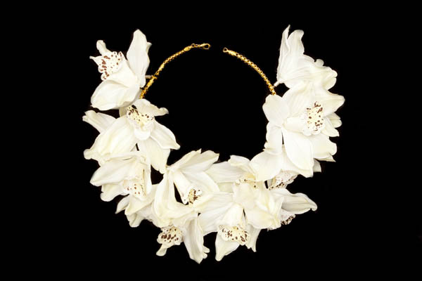 A Necklace Of Golden Metal Beads Decorated With Eighteen Large White Silk Orchids